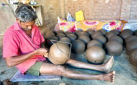 SRK Ramu, president of the Potters’ Association, shapes earthen pots at his kiln in Melakondayapettai. He says potters grapple with rising costs as they source clay from private players.
