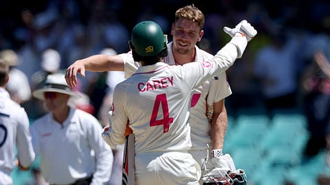 Australia’s Cameron Green (R) and teammate Alex Carey celebrate after hitting the winning runs on day five of the fifth Ashes cricket Test match between Australia and England at the SCG in Sydney on January 8, 2026.