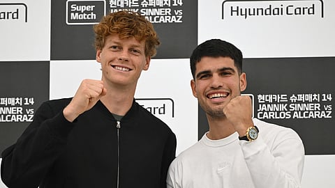Italy's Jannik Sinner (L) and Spain's Carlos Alcaraz (R) pose for a photo during a press conference in Seoul on January 9, ahead of their exhibition match. (Photo | AFP)