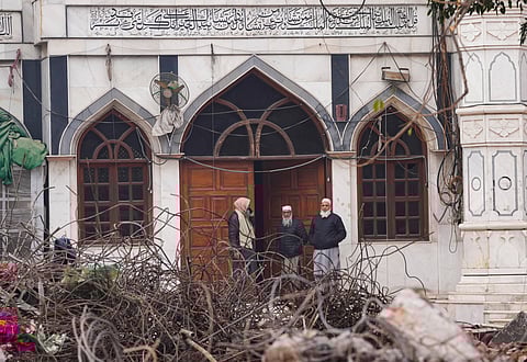 Men stand at the entrance of Syed Faiz Elahi mosque amid debris after demolition of alleged encroachments on land adjoining the mosque by the Municipal Corporation of Delhi (MCD), in the Turkman Gate area of New Delhi, Thursday, Jan. 8, 2026.