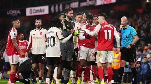Players react to Arsenal's Gabriel Martinelli after he moved Liverpool's Conor Bradley, not in photo, who was injured off the pitch during the English Premier League soccer match in London, Thursday Jan. 8, 2026.