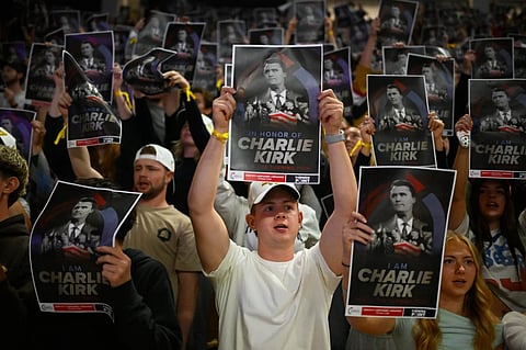 People hold posters of Charlie Kirk during a Turning Point USA rally at Utah State University, as a part of the organization’s push to memorialize Kirk, Sept. 30, 2025, in Logan, Utah.