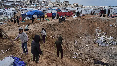 Palestinians inspect the damage at a displacement camp following an Israeli strike in Gaza City, Friday, Jan. 9, 2026.
