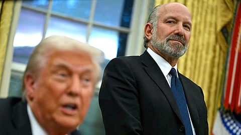 US President Donald Trump speaks to the press after signing an executive order, alongside US Secretary of Commerce nominee Howard Lutnick (R), in the Oval Office of the White House in Washington, DC, on February 10, 2025.