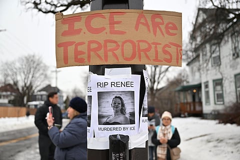 People gather around a makeshift memorial honoring the victim of a fatal shooting involving federal law enforcement agents, near the site of the shooting, Thursday, Jan. 8, 2026,