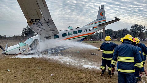 Firefighters douse a fire after a small aircraft carrying four passengers and two crew members crashed at Raghunathpali area, in Rourkela, Odisha.