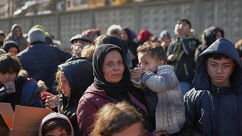 Civilians evacuate an area of the Sheikh Maqsoud neighborhood, where clashes between government forces and Kurdish fighters have been taking place in the northern city of Aleppo, Syria, Saturday, Jan. 10, 2026.