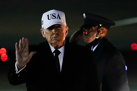 President Donald Trump waves after arriving on Air Force One from Florida, Sunday, Jan. 11, 2026, at Joint Base Andrews