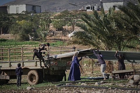 Palestinian residents of Ras Ein al-Auja village, West Bank pack up their belongings and prepare to leave their homes after deciding to flee mounting settler violence, Sunday, Jan. 11, 2026.