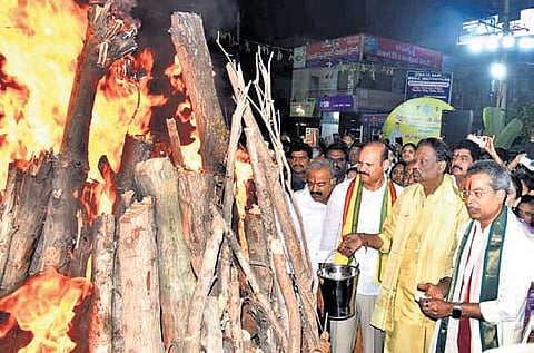 I&PR Minister Kolusu Parthasarathi takes part in Bhogi festivities at Gollapudi on the outskirts of Vijayawada on Wednesday.