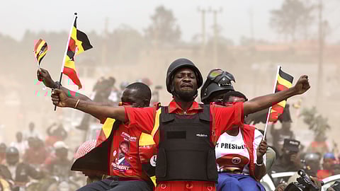 Ugandan opposition presidential candidate Robert Kyagulanyi Ssentamu, who is known as Bobi Wine, waves to supporters at an election campaign rally in Mukono, Uganda, Friday, Jan. 9, 2026.
