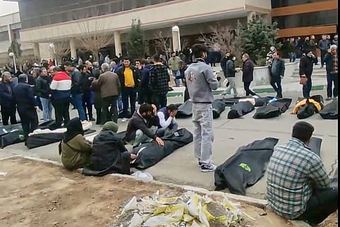 This frame grab shows an image from a morgue with dozens of bodies and mourners after a crackdown on the outskirts of Iran's capital, in Kahrizak, Tehran Province.