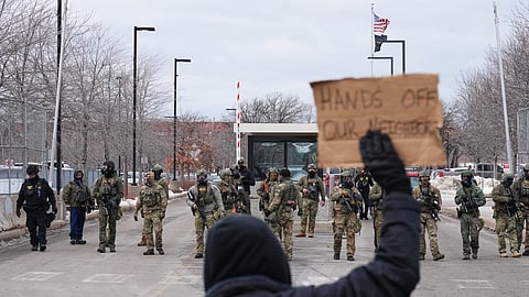 Protesters confront federal immigration officers outside the Bishop Henry Whipple Federal Building on Tuesday, Jan. 13, 2026, in Minneapolis.