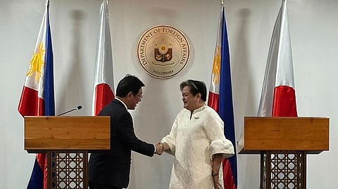 Japanese Foreign Minister Toshimitsu Motegi, left, and Philippine Foreign Secretary Theresa Lazaro shake hands in Manila, Thursday, Jan. 15, 2026.