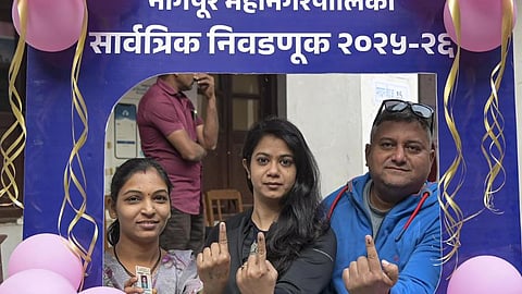 People show their ink-marked fingers after casting votes at a polling station during the Nagpur Municipal Corporation (NMC) elections, in Nagpur, Maharashtra, Thursday, Jan. 15, 2026.