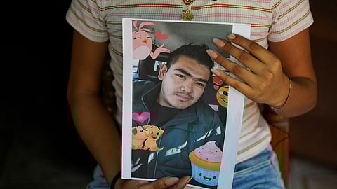 Jade, 16, holds a picture of her father, Jose Roger Urquilla, in her home in El Rosario, El Salvador, on December 3, 2025.