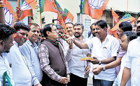 BJP leaders and supporters celebrate the party’s win in the Maharashtra local body elections, in Bengaluru on Friday.