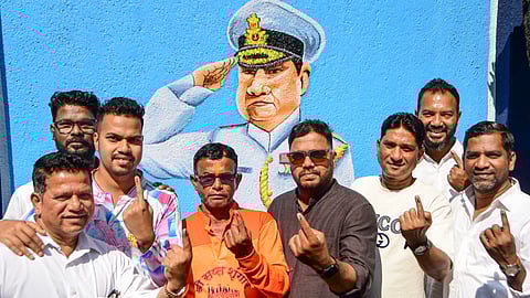 : Voters show their ink-marked fingers after casting their votes at a polling station during the Brihanmumbai Municipal Corporation elections in Mumbai, Maharashtra.
