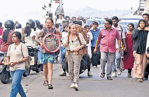 Foreign nationals and domestic tourists arriving at Fort Kochi.
