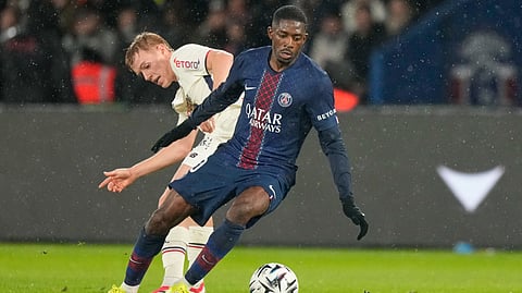 PSG's Ousmane Dembele, right, challenges for the ball with Lille's Hakon Arnar Haraldsson during the French League One soccer match between Paris Saint-Germain and Lille in Paris, France, Friday, Jan. 16, 2026.