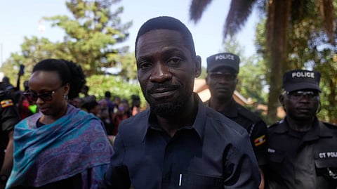 Uganda opposition presidential candidate Robert Kyagulanyi Ssentamu, famously known as Bobi Wine of the National Unity Platform (NUP), arrives with his wife to cast their votes during the presidential election at a polling station in Kampala, Uganda, Thursday, Jan. 15, 2026.