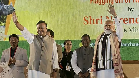 Prime Minister Narendra Modi, right, with Assam Chief Minister Himanta Biswa Sarma, waves to the gathering during the 'Bhoomi Pujan' ceremony of the Kaziranga Elevated Corridor Project, in Kaliabor, Assam.