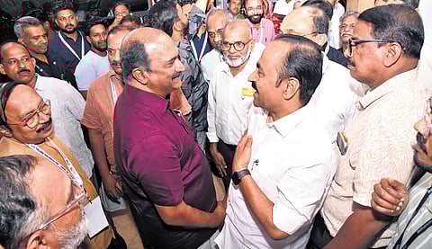 Finance Minister K N Balagopal and Leader of Opposition V D Satheesan interact during the concluding session of the India International Industrial Expo held at Angamaly on Sunday.