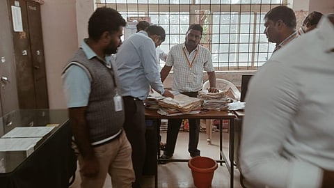 Lokayukta police personnel inspect documents during a raid at an office in Nagamangala taluk, Mandya district, on January 14, 2026.