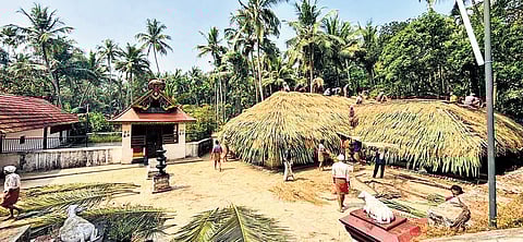 Locals and traditional craftsmen engaged in the re-roofing work of the ancestral tharavadu linked to the Azhavil Kariyathan temple