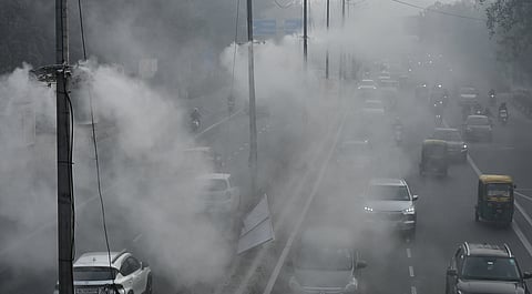 In this photo from December 27, 2025, a pole-mounted mist spray system operates in New Delhi to curb pollution amid worsening air quality.