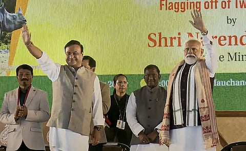 Prime Minister Narendra Modi, right, with Assam Chief Minister Himanta Biswa Sarma, waves to the gathering during the 'Bhoomi Pujan' ceremony of the Kaziranga Elevated Corridor Project, in Kaliabor, Assam.