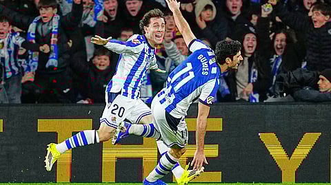 Real Sociedad's Goncalo Guedes, right, celebrates with Real Sociedad's Alvaro Odriozola after scoring his side's second goal during the Spanish La Liga soccer match between Real Sociedad and Barcelona on Jan. 18, 2026. 