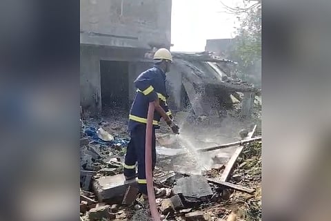 A fire personnel engaged in extinguishing the fire at the unit following the explosion on Sunday 