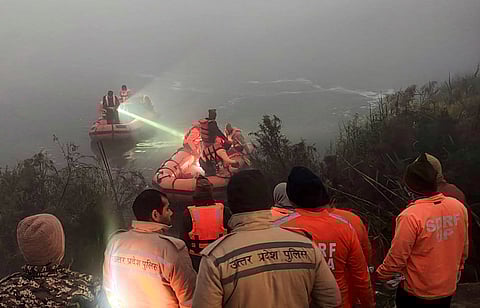 Police and State Disaster Response Force (SDRF) personnel conduct a search operation after a 27-year-old software engineer died on Saturday after his car went out of control and fell into a 20-feet-deep water-filled pit that was dug for the basement of an under-construction building, in Noida, Sunday, Jan. 18, 2026.