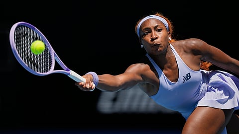 Coco Gauff of the U.S. plays a forehand return to Kamilla Rakhimova of Uzbekistan during their first round match at the Australian Open tennis championship in Melbourne, Australia, Monday, Jan. 19, 2026.