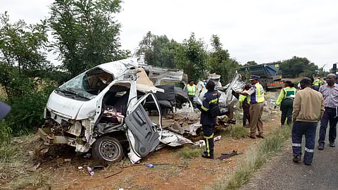 Police inspects the scene of a collision between a truck and a minibus carrying school children in Vanderbijlpark, South of Johannesburg, South Africa, Monday, Jan. 19, 2026.