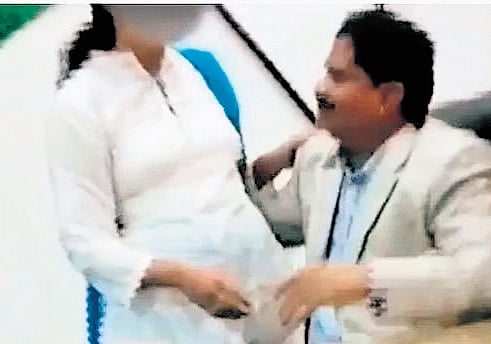 A video grab purportedly showing DGP K Ramachandra Rao with a woman inside his chamber.