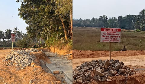 The compound wall being built for the project has cut off the only access road to the colony.