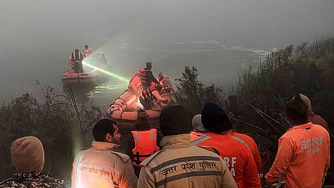 File | Police and State Disaster Response Force (SDRF) personnel conduct a search operation after a 27-year-old software engineer died on Saturday after his car went out of control and fell into a 20-feet-deep water-filled pit that was dug for the basement of an under-construction building, in Noida, Sunday, Jan. 18, 2026.