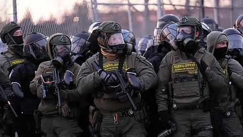 US federal officers stand outside the Bishop Henry Whipple Federal Building during a protest on Saturday, Jan. 17, 2026, in Minneapolis.