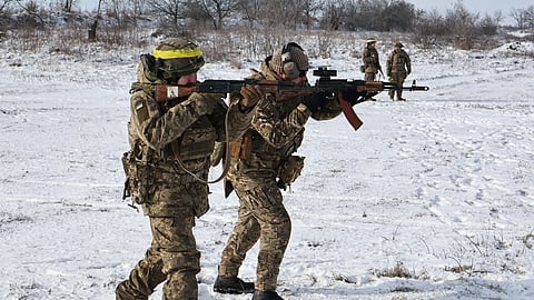 In this photo provided by Ukraine's 65th Mechanized Brigade press service, recruits perform drills at a training ground in the Zaporizhzhia region, Ukraine, Tuesday, Jan. 20, 2026. 