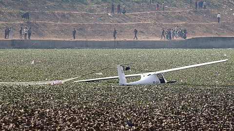 An Indian Air Force training aircraft crashes into a pond during a training session, in Prayagraj, Wednesday, Jan. 21, 2026.