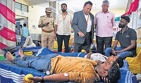 RTO Srinivas Prasad interacts with volunteers donating blood in Yeshwanthpur on Thursday.