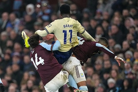 Everton's Thierno Barry, center, Aston Villa's Pau Torres, left, and Aston Villa's Ezri Konsa challenge for the ball during the English Premier League soccer match between Aston Villa and Everton in Birmingham, Sunday, Jan. 18, 2026.