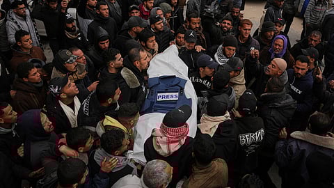 Mourners carry the body of Anas Ghoneim, one of the three Palestinian journalists who were killed in an Israeli strike on an Egyptian committee's vehicle, during his funeral in Khan Younis, southern Gaza Strip, Thursday, Jan. 22, 2026.