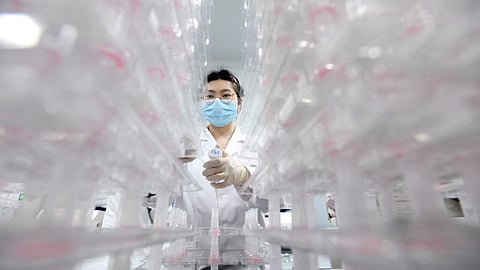A laboratory technician conducting artificial intelligence-based cervical cancer screening at a test facility in Wuhan, China