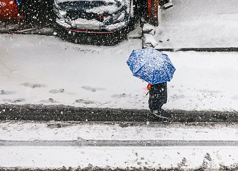 A citizen walks amid heavy snowfall at Bhaderwah, in Doda district, Jammu and Kashmir, Friday, Jan. 23, 2026. 