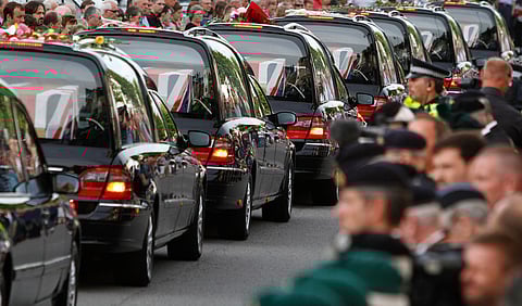 The coffins of seven British soldiers killed in Afghanistan, are driven through the town of Wootton Bassett, England, after repatriation to Britain, Tuesday, June 29, 2010. 