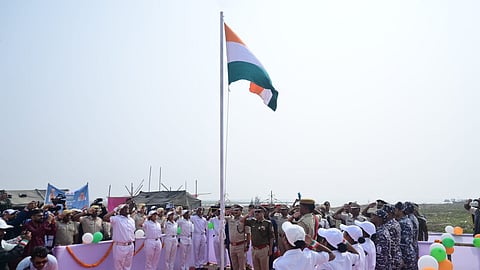 DGP YB Khurania and other officials saluting the national flag after it was unfurled at Udabali island 