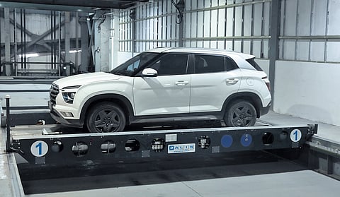 A car is loaded onto the transmitter at the automated multi-level parking complex in Nampally, Hyderabad.